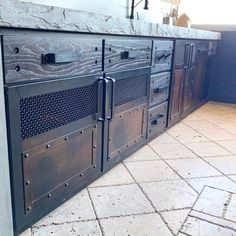 an old fashioned oven is sitting on the floor in front of a wall with several doors