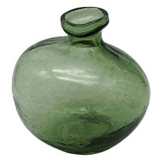 a green glass vase sitting on top of a table