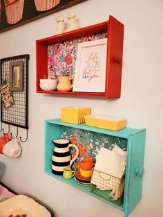 the shelves are decorated with colorful dishes and cupcakes on them in this kitchen