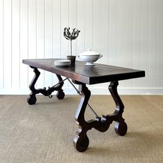 a wooden table with two bowls on it and one bowl sitting on top of the table