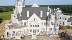 an aerial view of a large white castle with two towers and three storyed rooms