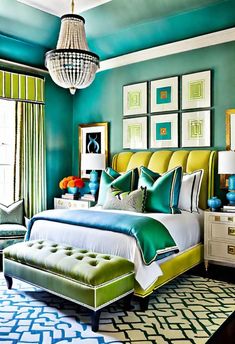 a bedroom with green and blue walls, pictures on the wall and a white bed