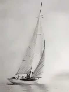 a black and white photo of a sailboat on the water