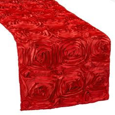 a long red table runner with roses on the top and bottom, along with a white background