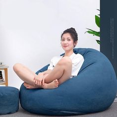 a woman is sitting on a bean bag chair