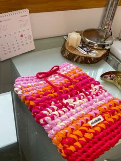 a handbag sitting on top of a counter next to a calendar and other items