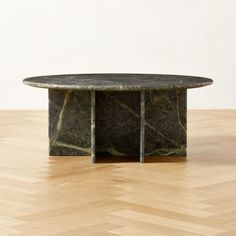 a marble coffee table on top of a hard wood floor