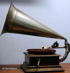 an antique record player with a brass horn