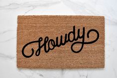 a door mat with the word slowly written on it in cursive black ink