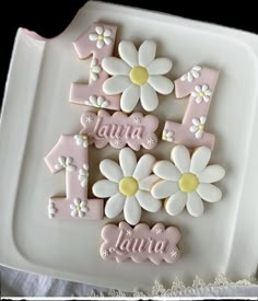 a cake decorated with flowers and the number one