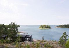 an island sits in the middle of a large body of water surrounded by wooded area