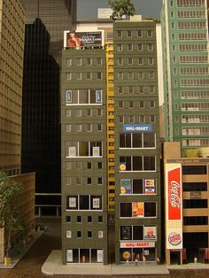 a toy model of a building in the middle of a city with tall buildings behind it