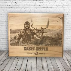 a wooden plaque with an image of a deer and the words casey keefer on it