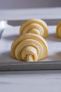 some food that is on top of a metal baking sheet with a spoon in it