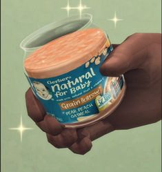 a hand holding an ice cream container in it's right hand, with the label natural for baby