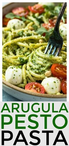 a close up of a plate of pasta with pesto and mozzarella sauce