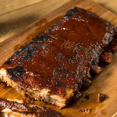 ribs covered in bbq sauce on a cutting board