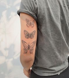 a man with three butterflies on his arm