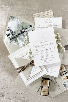 the wedding stationery is laid out neatly on top of each other, including cards and envelopes