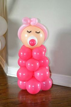 there is a balloon shaped like a girl with pink hair and eyes on her head