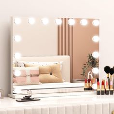 there is a vanity mirror with lights on it and makeup brushes in front of the mirror