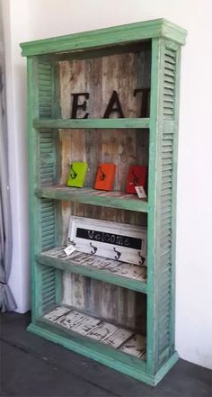 an old green bookcase with letters on it