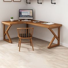 a desk with a chair and computer on it in front of a wall mounted shelf