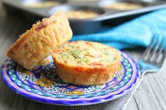 two muffins on a blue and white plate with a fork next to it