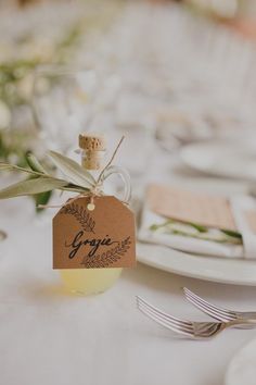 a table set with place cards and silverware for guests to enjoy the meal on