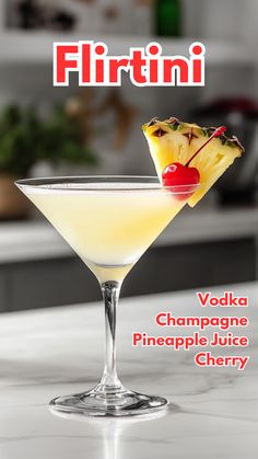 there is a martini with pineapple and cherries in it