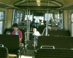 people are sitting on the bus with their backs to each other as they look out the window