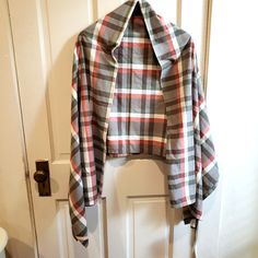 a plaid jacket hanging on the front door