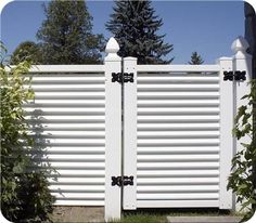 an image of a white fence that is in the grass