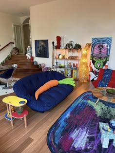 a living room filled with lots of furniture and colorful rugs on top of hard wood flooring