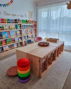 a child's playroom with toys and bookshelves