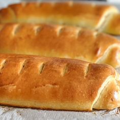 two loaves of bread sitting on top of a table