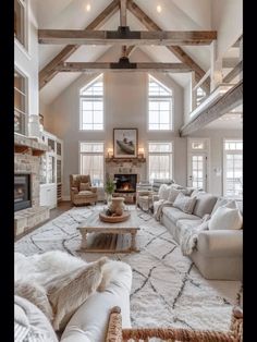 a living room filled with furniture and a fire place in the middle of an open floor plan