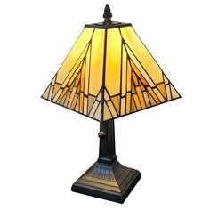 a lamp that is sitting on top of a wooden stand with a glass shade over it