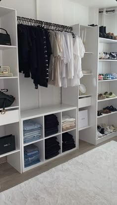 a white closet filled with lots of clothes