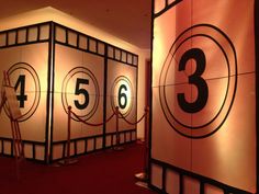 the numbers are on display in front of red carpeted flooring and white walls