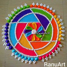 this is an image of a colorful art work on the floor with beads and pearls