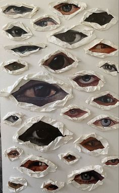 an art piece with many different types of eyes on it, all made out of paper