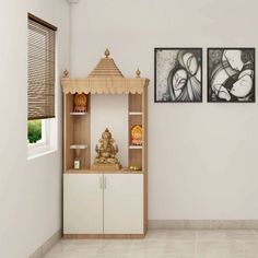 a room with two paintings on the wall and a buddha statue in front of it