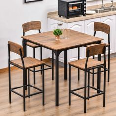 a kitchen table with four chairs and a toaster oven