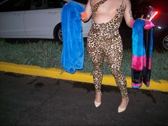 a woman in leopard print clothing holding two towels