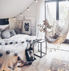 a bedroom with a hammock hanging from the ceiling and other items on the bed