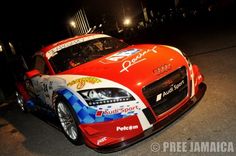 an audi sports car parked on the street at night