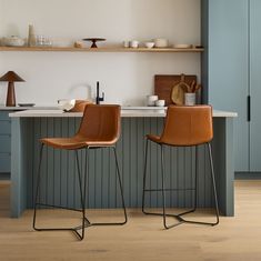 two brown chairs sitting on top of a kitchen counter