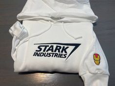 Stark Industries Embroidered Hoodie; ironman embroidered Hoodie; ironman Hoodies; Stark industries crewneck; gift for her/him custom shirtIF YOU WANT DIFFERENT THREAD COLOR PLEASE SEND ME A MESSAGE OR LEAVE ME A NOTE! OTHERWISE WE WILL SEND THE LISTING COLOR!Depending on availability we may send jerzees or gildanSizes: S, M, L, XL, 2XL, 3XLFeatures8 oz., 50% cotton, 50% polyester1x1 ribbed collar, cuffs and waistband with spandexDouble-needle stitching throughoutPill-resistant air jet yarnSet-in Ironman Embroidery, Iron Man Hoodie, Avengers Hoodie, Iron Man Shirt, Iron Man Marvel, Toni Stark, Stark Industries, Marvel Clothes, Marvel Hoodies