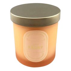 an orange candle with a black lid on a white background and the words yogurt written in gold